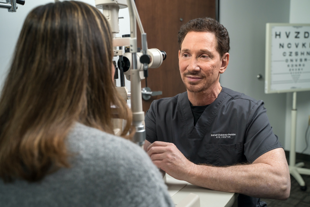 Dr. Scott Perkins giving a comprehensive eye exam to a woman