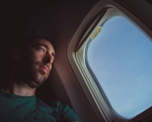 man on a plane looking out the window