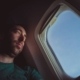 man on a plane looking out the window